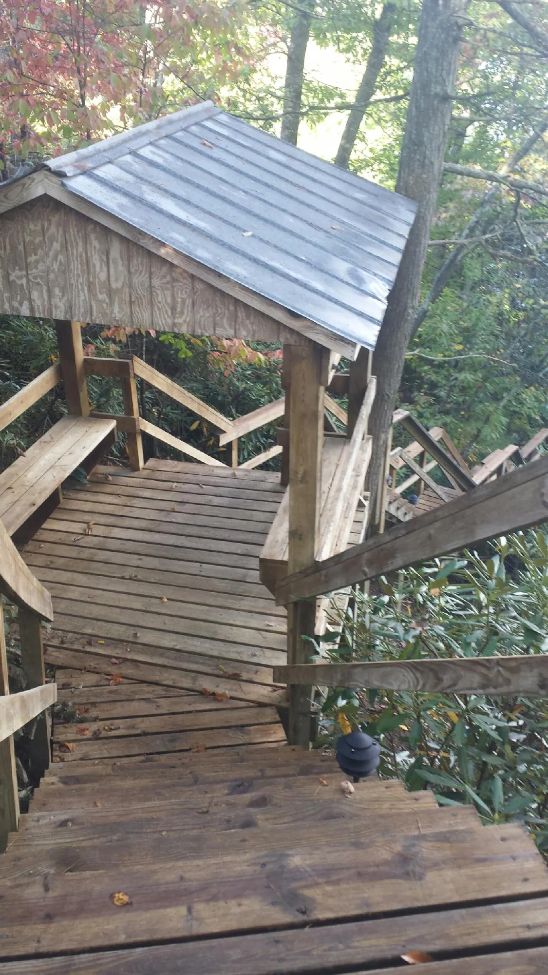 Metal roofed shelter over wooden steps on a wooded walkway — Skylight Repair & Installation work by our crew in South Windham